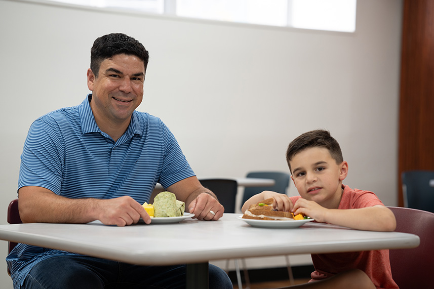 Father and son with a healthy lunch at Driscoll Childrens cafeteria.